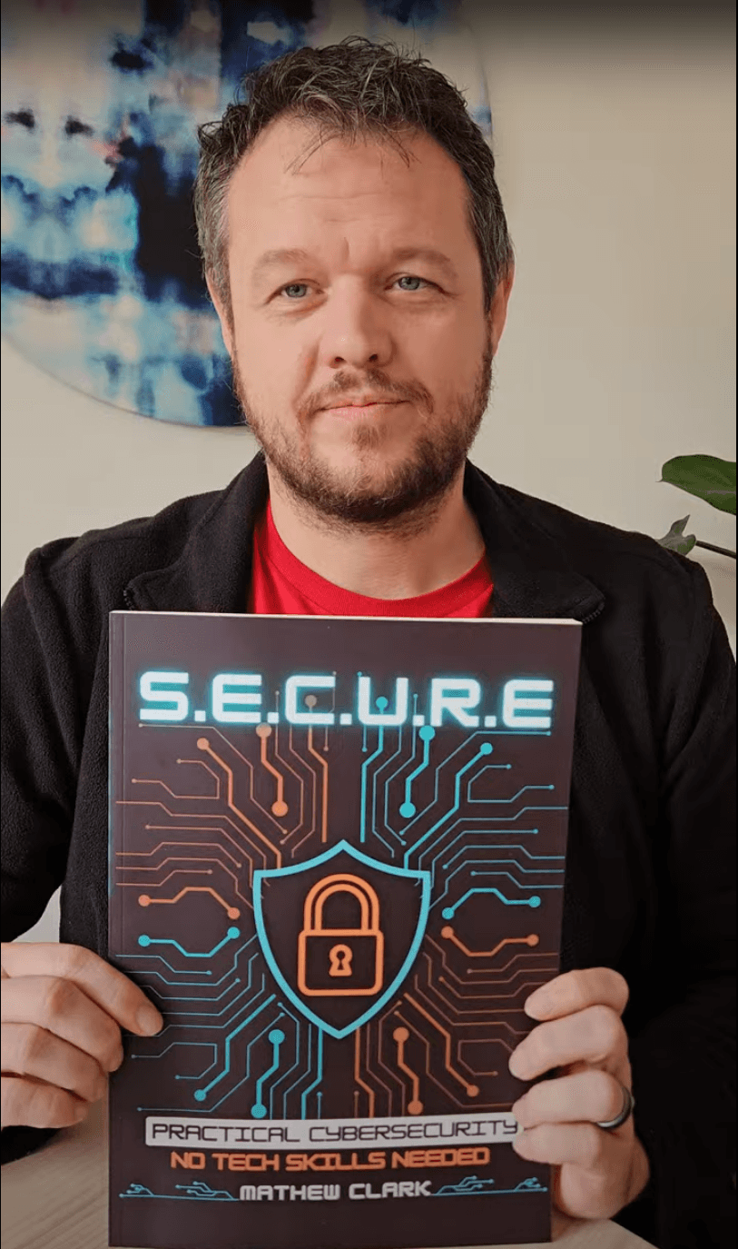 Mathew Clark holding the S.E.C.U.R.E. cybersecurity guide